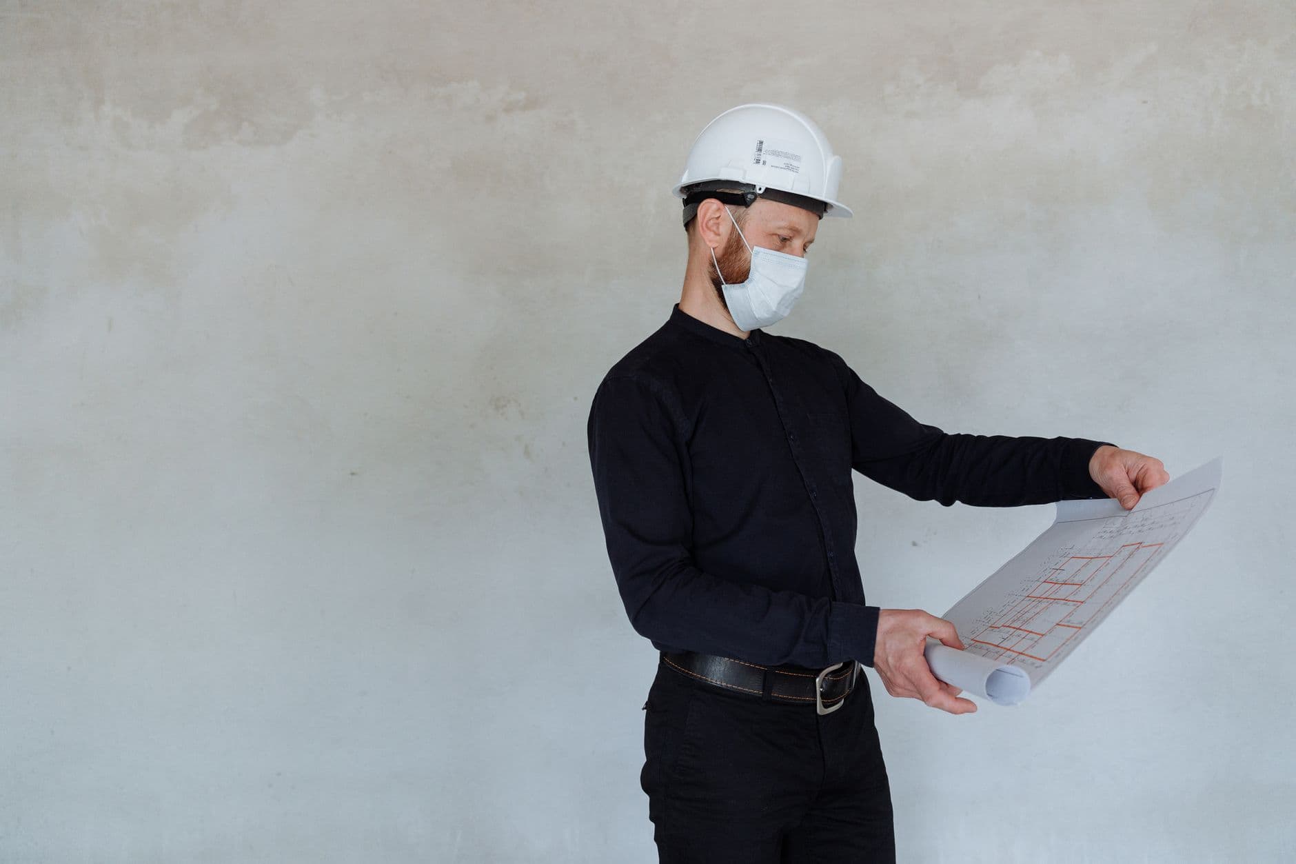 A construction engineer reviewing blueprints on a job site